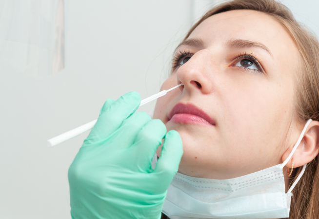 Un professionnel de santé réalise un test naso-pharyngé